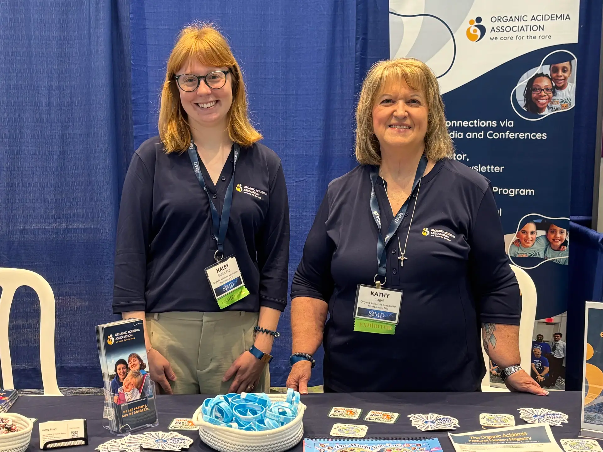 Organic Acidemia Association representatives Kathy and Haley at a conference booth.